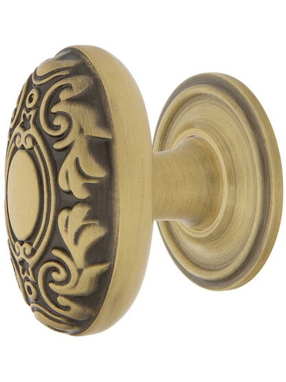 Decorative Oval Cabinet Knob - 1 1/8 inch x 1 3/4 inch with Classic Rosette in Antique Brass.